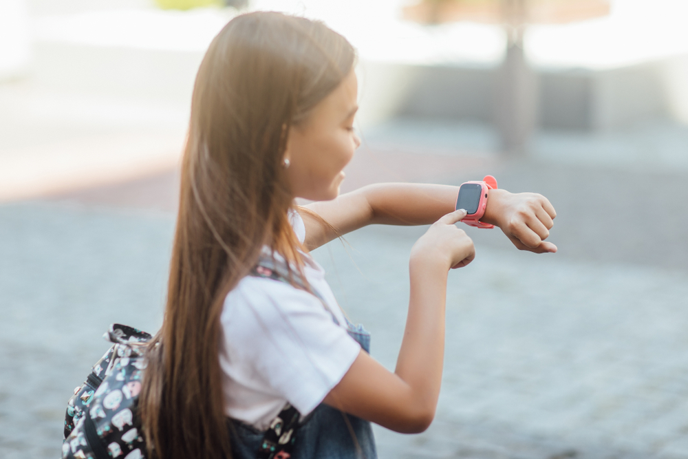 children girl wearing smartwatch