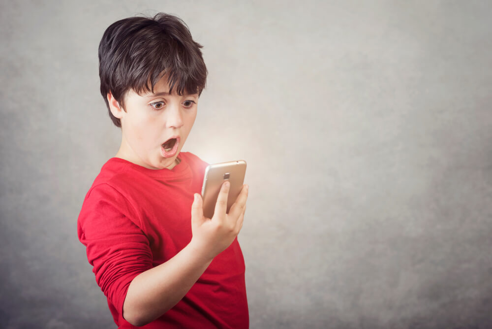 surprised child mobile phone